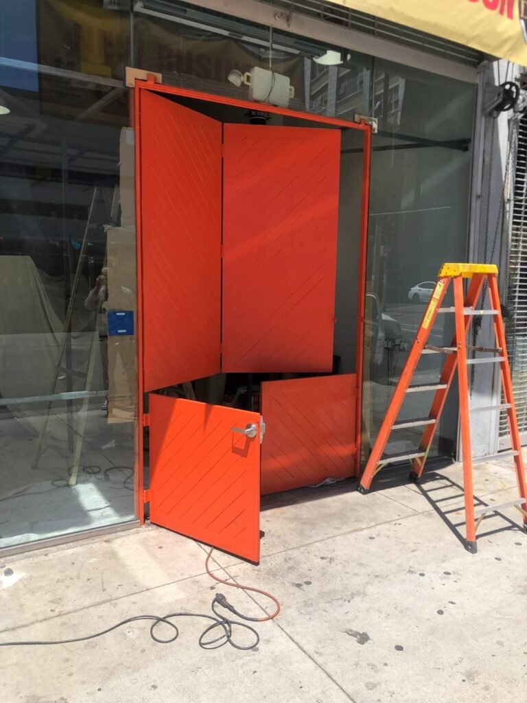 Custom red-painted steel storefront entry frame and doors fabricated for a new business in Downey