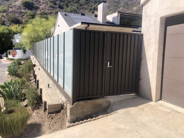 Frosted glass panel fence with a solid steel double gate in La Cañada Flintridge