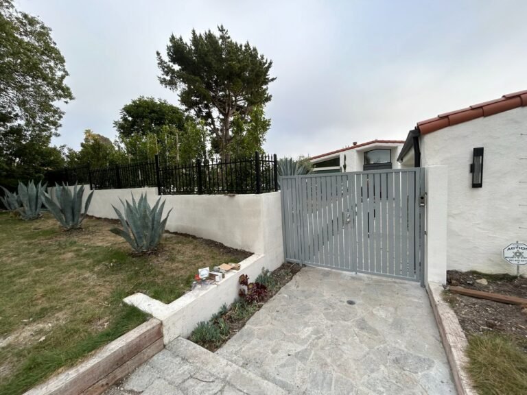 Gray solid steel side gate at the end of a garden walkway in Agoura Hills