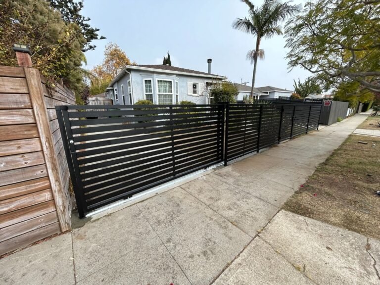 Black horizontal slat steel fence along a sidewalk in Westchester