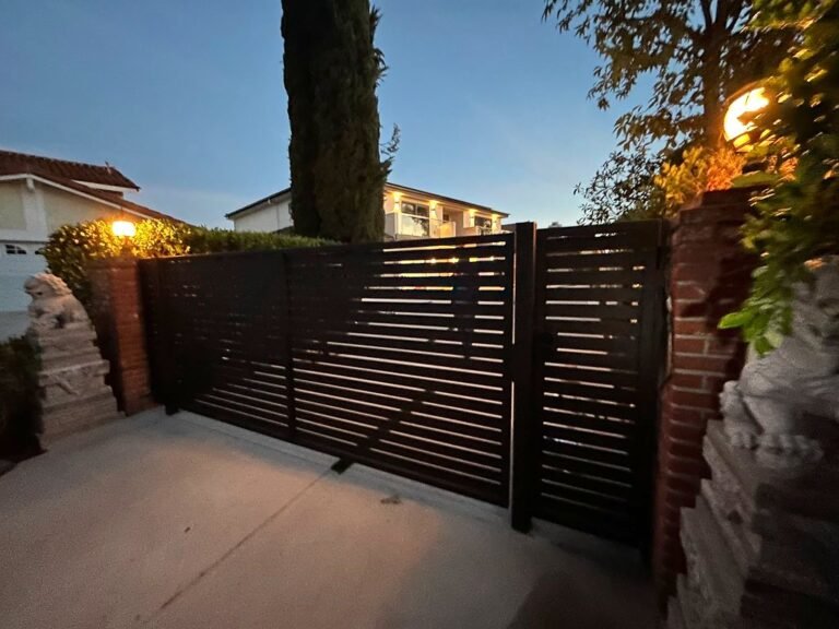 Modern horizontal slat iron gate at dusk