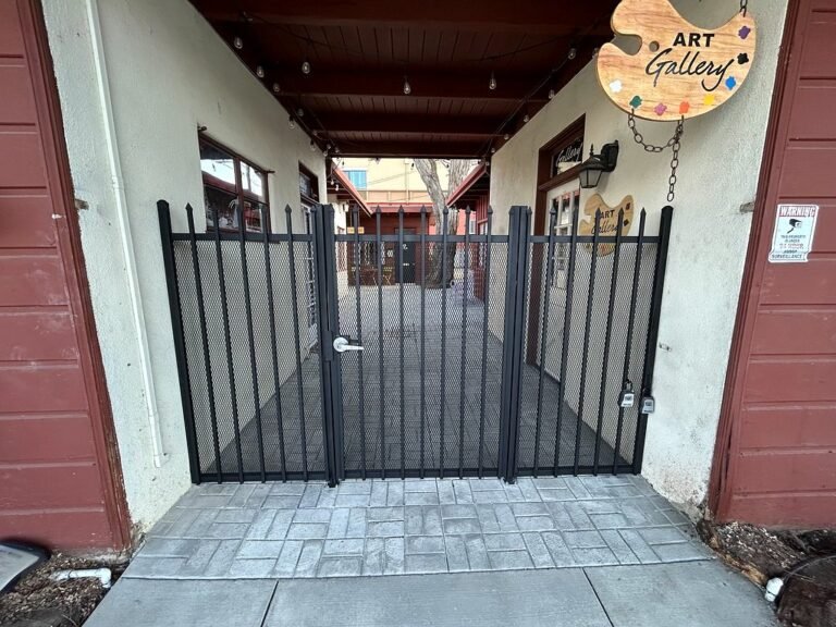 Black iron double gate at the entrance of a commercial courtyard