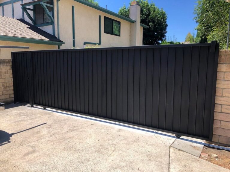 Solid black steel sliding driveway gate