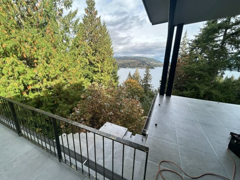 Black steel deck and stair railings on a covered patio overlooking a lake in Westlake Village