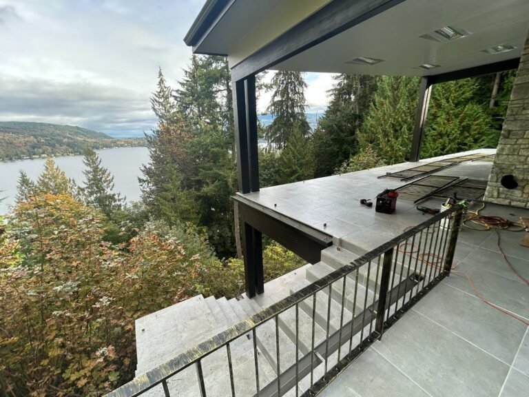 Black steel deck and stair railings on a covered patio overlooking a lake in Westlake Village
