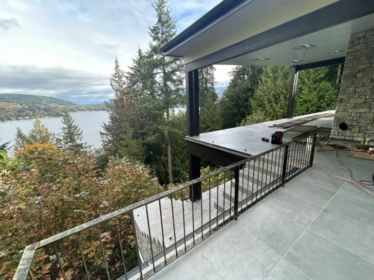 Black steel deck and stair railings on a covered patio overlooking a lake in Westlake Village