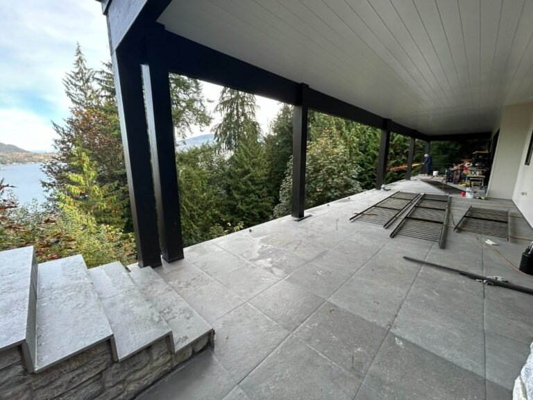 Black steel deck and stair railings on a covered patio overlooking a lake in Westlake Village