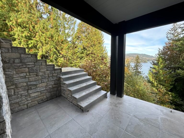 Black steel deck and stair railings on a covered patio overlooking a lake in Westlake Village