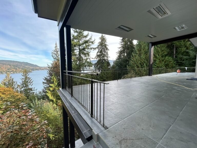 Black steel deck and stair railings on a covered patio overlooking a lake in Westlake Village