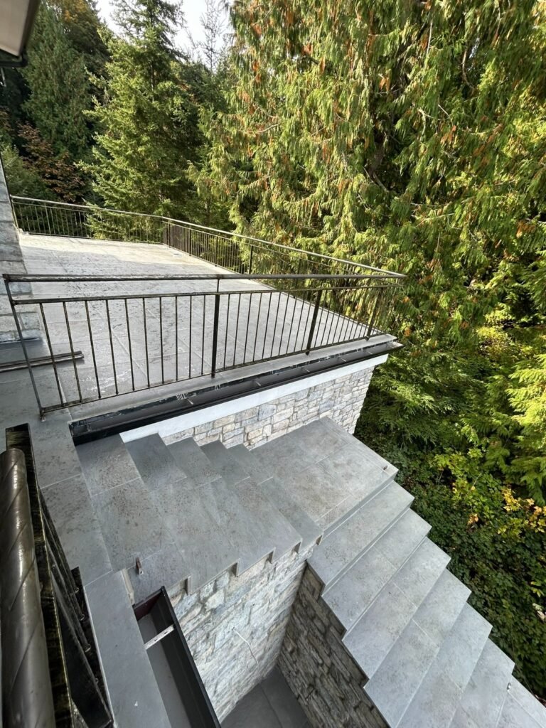 Black steel deck and stair railings on a covered patio overlooking a lake in Westlake Village