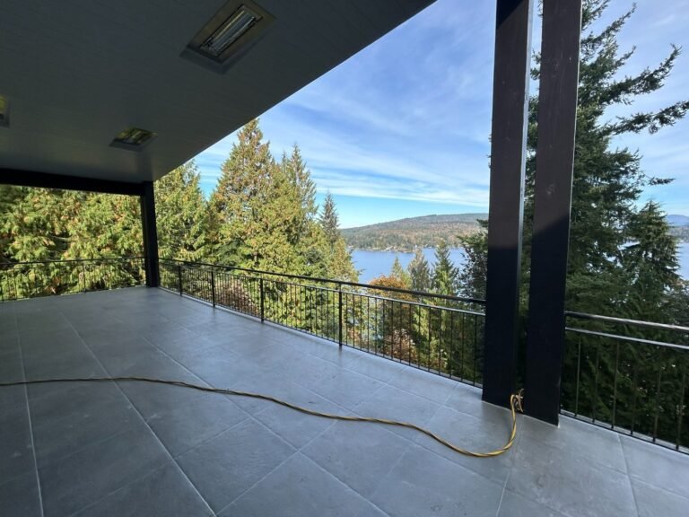 Black steel deck and stair railings on a covered patio overlooking a lake in Westlake Village