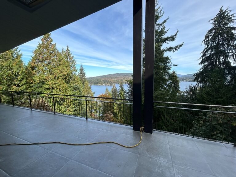 Black steel deck and stair railings on a covered patio overlooking a lake in Westlake Village