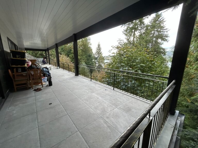 Black steel deck and stair railings on a covered patio overlooking a lake in Westlake Village