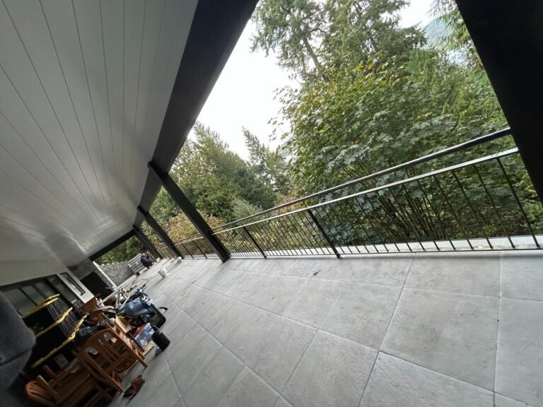 Black steel deck and stair railings on a covered patio overlooking a lake in Westlake Village