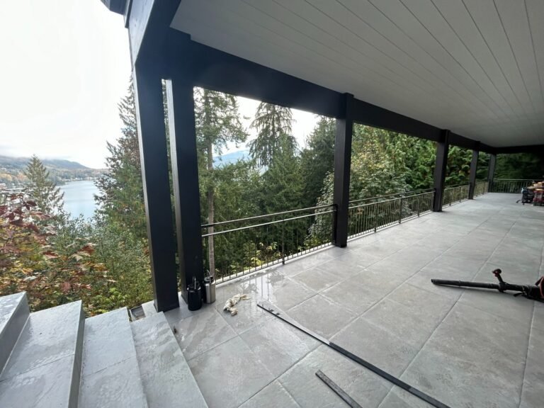 Black steel deck and stair railings on a covered patio overlooking a lake in Westlake Village