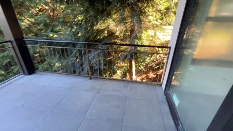 Black steel deck and stair railings on a covered patio overlooking a lake in Westlake Village