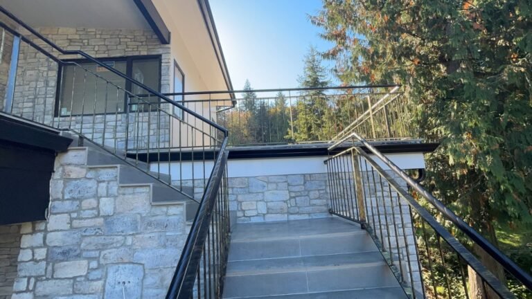 Black steel deck and stair railings on a covered patio overlooking a lake in Westlake Village