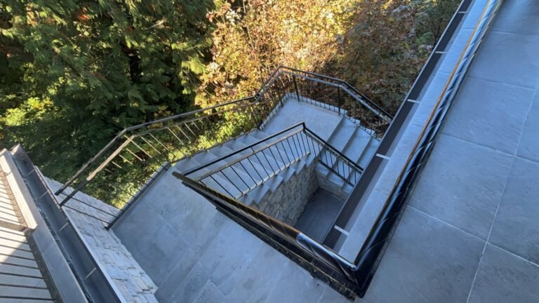Black steel deck and stair railings on a covered patio overlooking a lake in Westlake Village