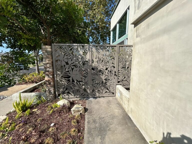 Laser-cut decorative steel panel side gate with a leaf pattern in Eagle Rock