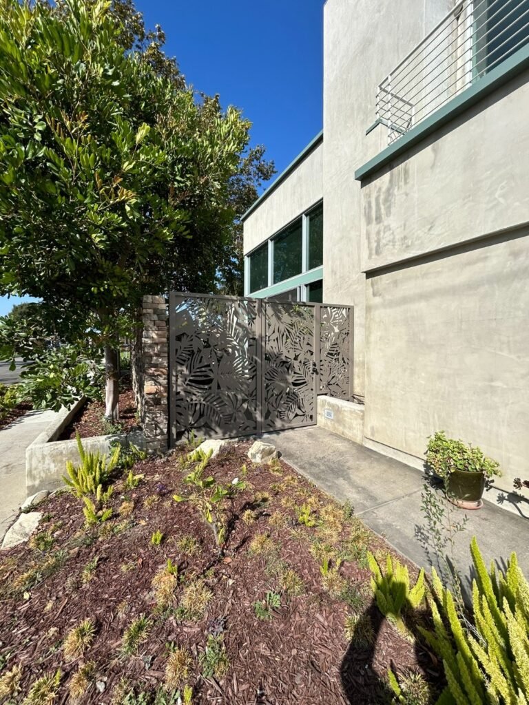 Laser-cut decorative steel panel side gate with a leaf pattern in Eagle Rock