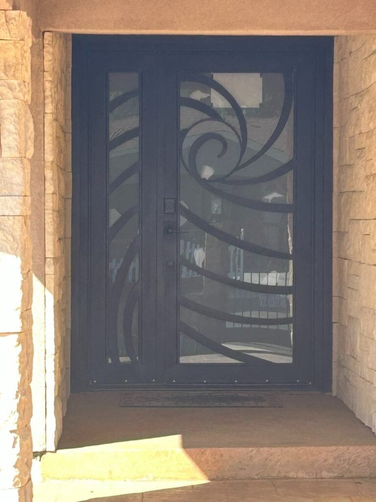 Modern wrought iron entry door with a sweeping wave design in Culver City