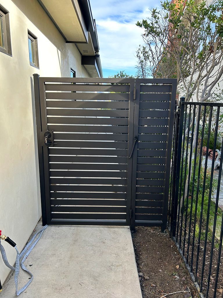 Modern horizontal slat iron side gate with matching fence