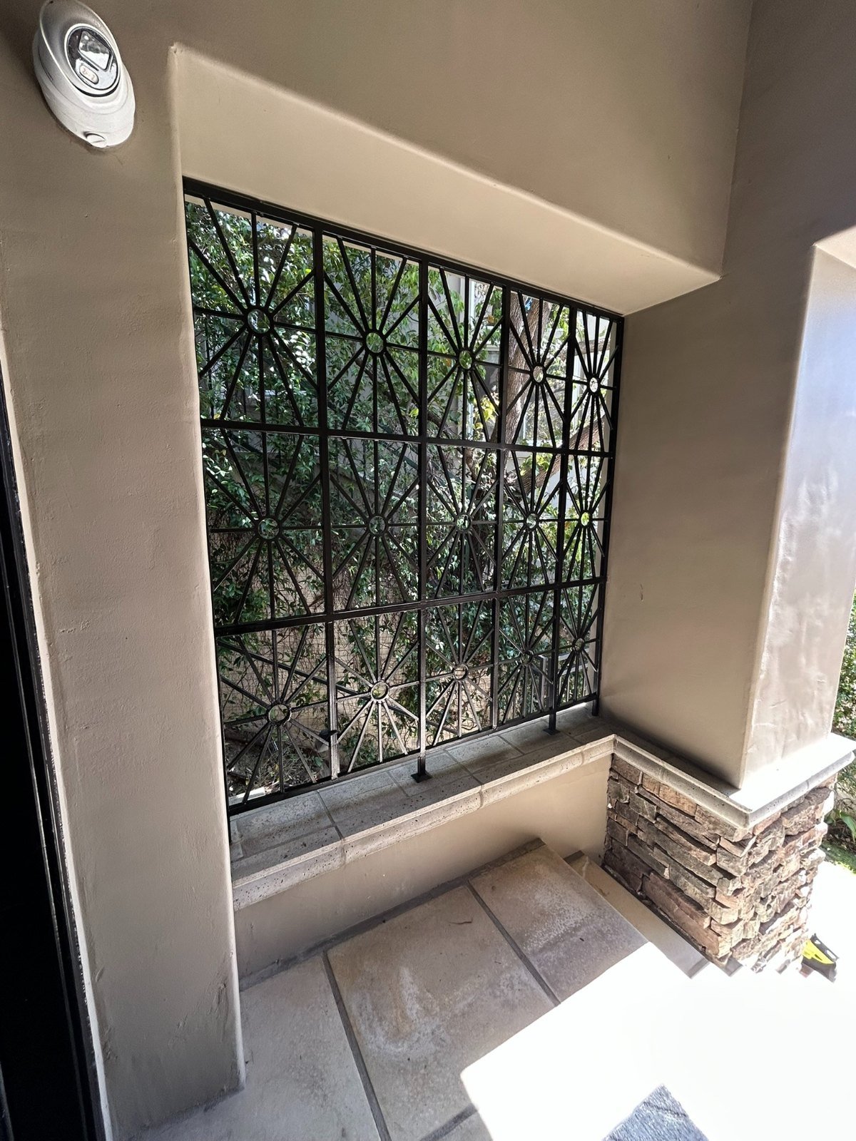 Modern geometric steel window security grille on a home in Diamond Bar