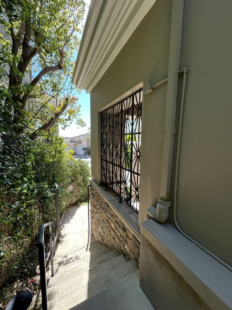 Modern geometric steel window security grille on a home in Diamond Bar