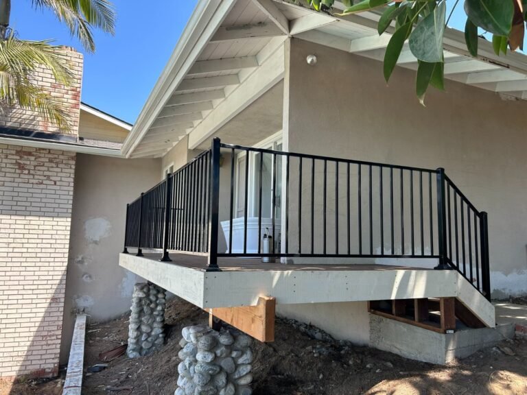 Black iron deck and stair railings overlooking a backyard pool in Castaic