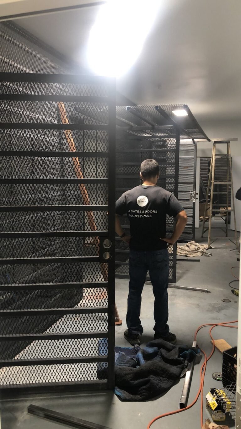 Black steel mesh security storage cages in a building corridor in Alhambra