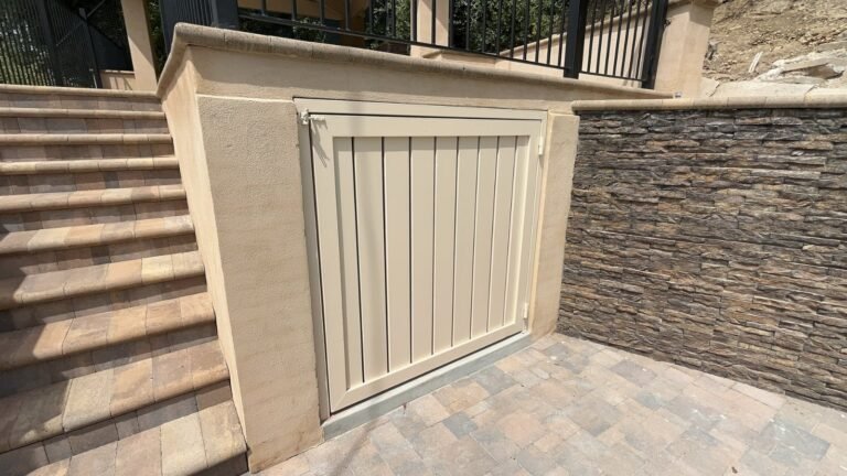 White steel panel access gate built under exterior stairs in Hermosa Beach